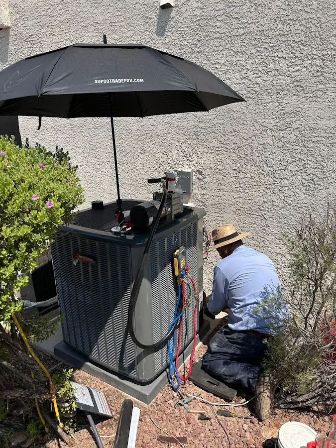 HVAC technician performing outdoor AC maintenance in Chaska